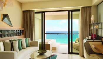 Turquoize at Hyatt Ziva Cancun adults-only all-inclusive gay-friendly hotel. Ocean view suite with balcony, seating area, and modern decor.