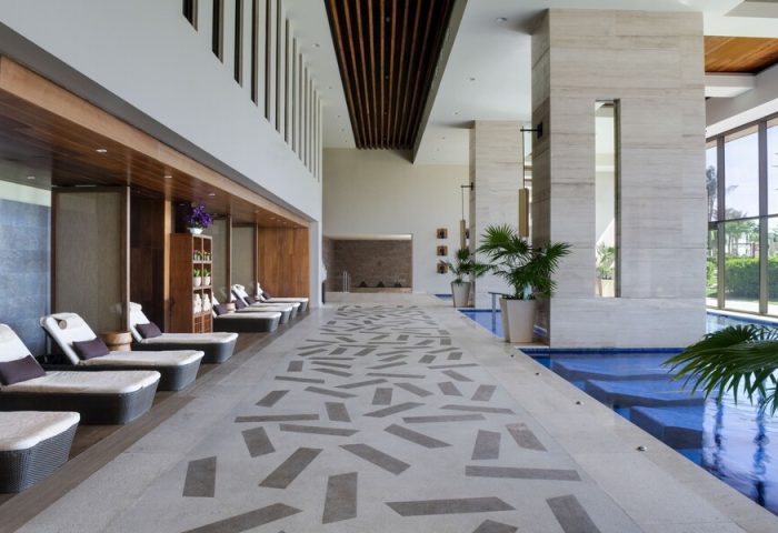 Turquoize at Hyatt Ziva Cancun adults-only all-inclusive gay-friendly hotel. Lounge chairs line an indoor pool, offering a relaxing spa experience.