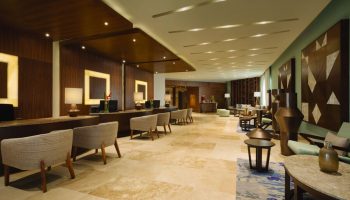 Lobby at Turquoize, Hyatt Ziva Cancun, an adults-only, all-inclusive, gay-friendly hotel. Reception and seating areas. Upscale design.