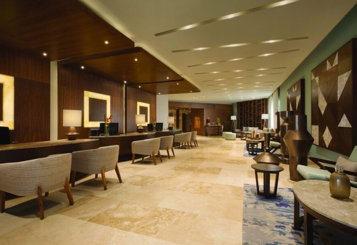 Lobby at Turquoize, Hyatt Ziva Cancun, an adults-only, all-inclusive, gay-friendly hotel. Reception and seating areas. Upscale design.