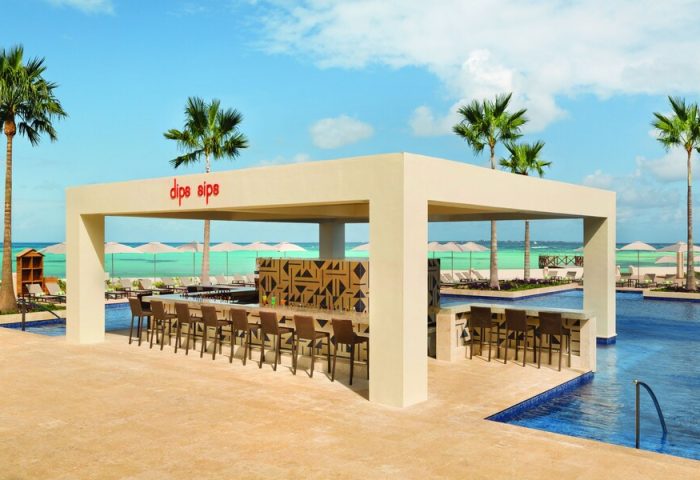 Turquoize at Hyatt Ziva Cancun adults-only all-inclusive swim-up bar. Palm trees, ocean view. Gay-friendly hotel for gay men's travel.