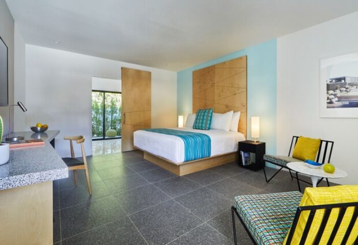 Twin Palms Resort, Palm Springs gay men's resort: Modern room with king bed, desk, and seating area. Gay-friendly hotel with stylish design.