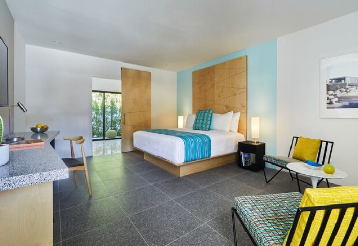 Twin Palms Resort, Palm Springs gay men's resort: Modern room with king bed, desk, and seating area. Gay-friendly hotel with stylish design.