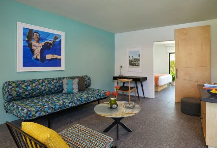 Twin Palms Resort, Palm Springs gay men's resort suite. Modern design, daybed, desk, and artwork featuring a man underwater.