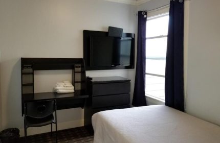 Twin Peaks Hotel room. Gay-friendly hotel with a desk, TV, and single bed. A comfortable and welcoming space for gay travelers.