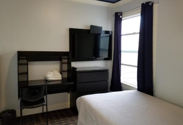 Twin Peaks Hotel room. Gay-friendly hotel with a desk, TV, and single bed. A comfortable and welcoming space for gay travelers.