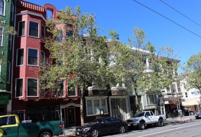 Twin Peaks Hotel: A gay-friendly hotel in San Francisco. Colorful Victorian buildings line the street, offering a welcoming vibe for gay travelers.