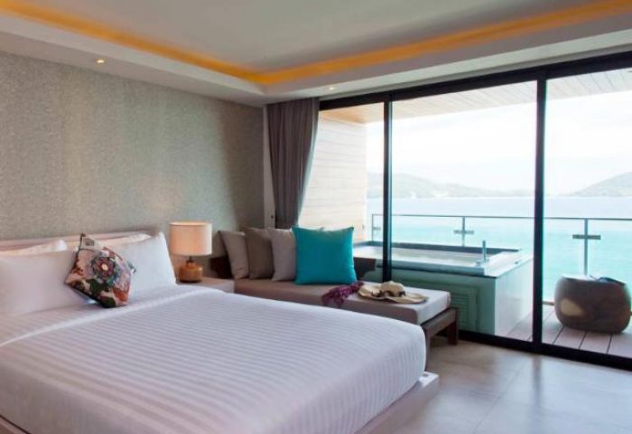 U Zenmaya Phuket Resort gay-friendly hotel room. King bed, daybed, and ocean view balcony with jacuzzi. Perfect for gay travelers.