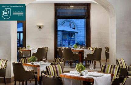 UNAHOTELS Decò Roma gay-friendly restaurant. Interior view with tables set for dining. Pet-friendly hotel with infection risk management.