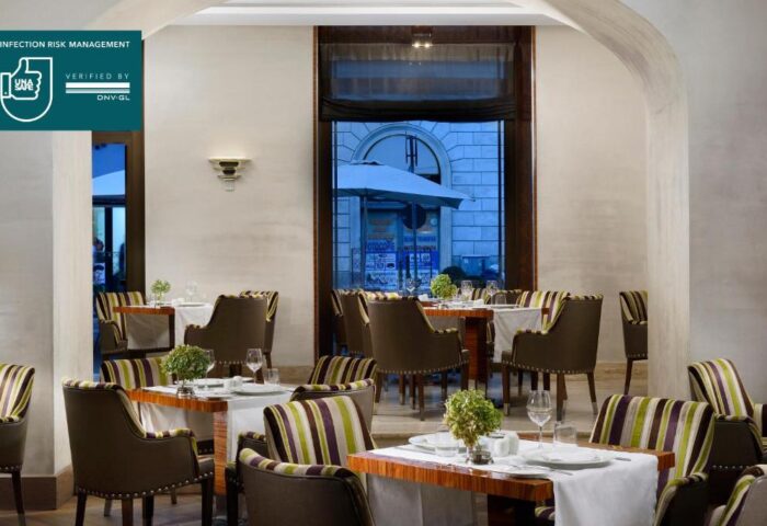 UNAHOTELS Decò Roma gay-friendly restaurant. Interior view with tables set for dining. Pet-friendly hotel with infection risk management.