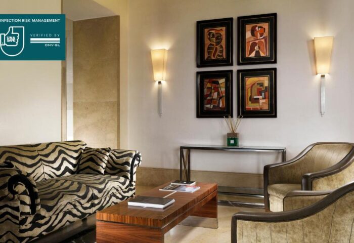 UNAHOTELS Decò Roma gay-friendly hotel: Pet-friendly lounge area with zebra-striped sofa, armchairs, and artwork. Stylish, comfortable space.