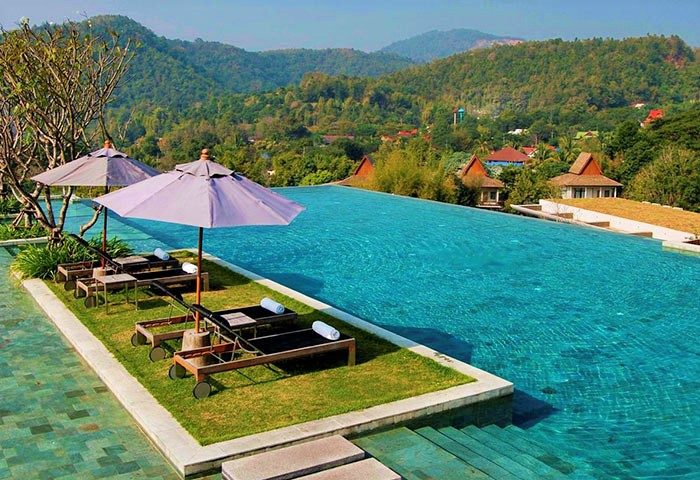 Veranda High Resort Chiang Mai MGallery infinity pool view. Gay-friendly hotel with mountain backdrop, perfect for gay men travel advice.
