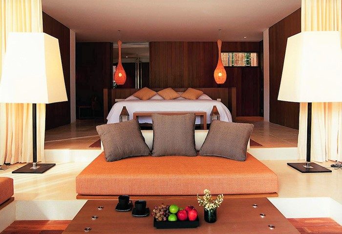 Veranda High Resort Chiang Mai MGallery room. Gay-friendly hotel's bedroom with bed, lamps, cushions, table, and fruits. Relaxing space.