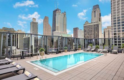 Rooftop pool at the gay-friendly Viceroy Chicago hotel. Skyline view with lounge chairs. Perfect for gay travelers visiting Chicago.