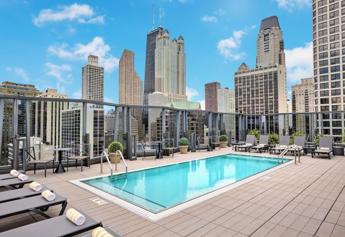 Rooftop pool at the gay-friendly Viceroy Chicago hotel. Skyline view with lounge chairs. Perfect for gay travelers visiting Chicago.
