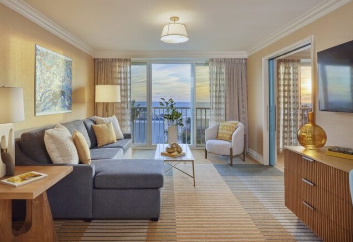 Viceroy Santa Monica gay-friendly hotel suite. Living room with ocean view, sofa, chair, and TV. Upscale gay travel accommodations.