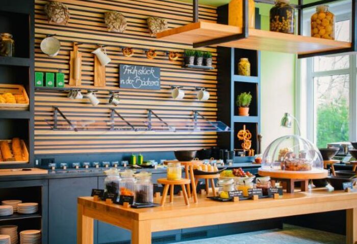Breakfast buffet at Vienna House Easy Berlin, a gay-friendly hotel. Fresh food, pastries, and drinks are available for guests' enjoyment.