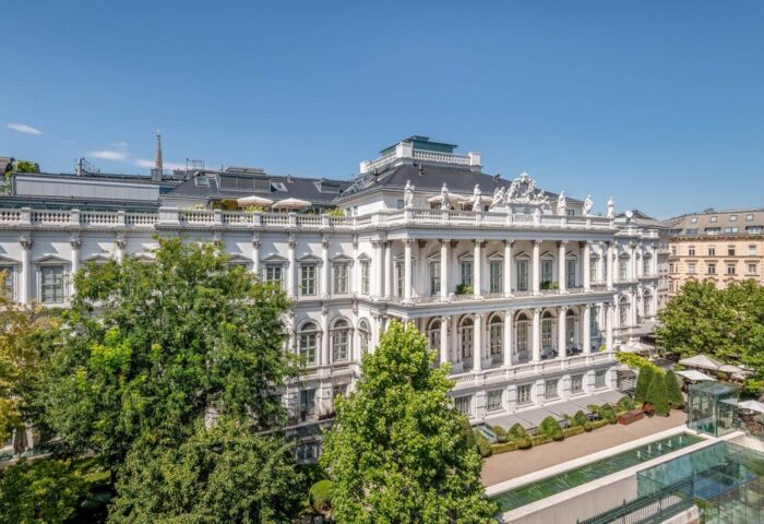 Facade of Vienna Marriott Hotel, a gay-friendly hotel in Vienna, Austria. The hotel has a classical design with white walls and columns.