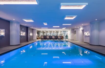 Indoor pool at Vienna Marriott Hotel, a gay-friendly hotel. Relax in style during your Vienna travel. Modern design with lounge chairs.