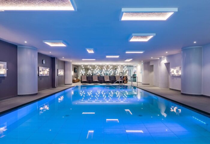 Indoor pool at Vienna Marriott Hotel, a gay-friendly hotel. Relax in style during your Vienna travel. Modern design with lounge chairs.