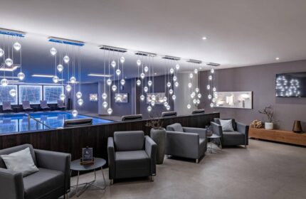 Vienna Marriott Hotel's gay-friendly amenities: a luxurious pool area with modern lighting and comfortable seating for relaxation.