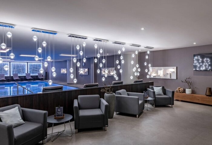 Vienna Marriott Hotel's gay-friendly amenities: a luxurious pool area with modern lighting and comfortable seating for relaxation.