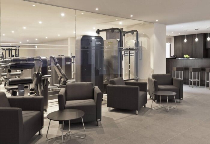 Vienna Marriott Hotel's gym. Gay-friendly Hotel in Vienna offers fitness center with modern equipment, lounge area, and bar for gay travelers.