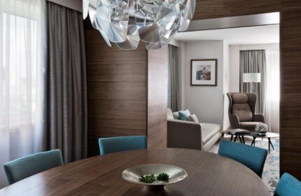 Vienna Marriott Hotel suite. Gay-friendly hotel with modern decor, dining table, and living area. Perfect for LGBT travelers in Vienna.