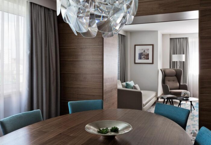 Vienna Marriott Hotel suite. Gay-friendly hotel with modern decor, dining table, and living area. Perfect for LGBT travelers in Vienna.