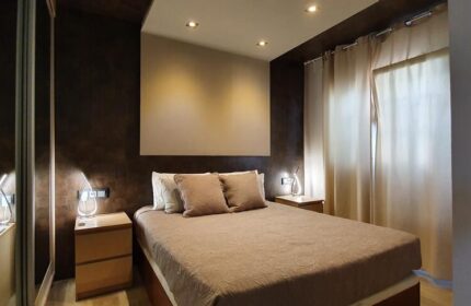 Villa Adler Gay Men Only: Bedroom with a double bed, bedside tables, and curtains. Gay-friendly hotel room interior design for gay men travelers.