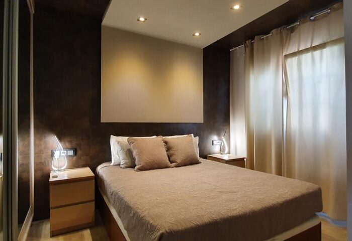 Villa Adler Gay Men Only: Bedroom with a double bed, bedside tables, and curtains. Gay-friendly hotel room interior design for gay men travelers.