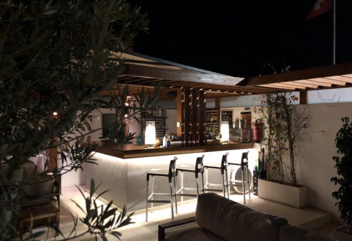 Villa Adler Gay Men Only hotel bar at night. Gay-friendly hotel with seating and drinks. Relaxing vacation spot.
