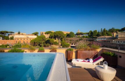 Villa Agrippina Gran Melia gay-friendly hotel rooftop pool view. Rome luxury travel for gay men. Relaxing poolside at this top hotel.