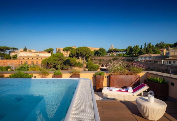 Villa Agrippina Gran Melia gay-friendly hotel rooftop pool view. Rome luxury travel for gay men. Relaxing poolside at this top hotel.