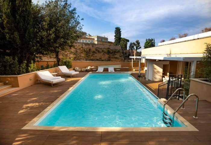 Villa Agrippina Gran Melia gay-friendly hotel pool view. Relaxing sun loungers by the pool. Ideal for gay travel in Rome, Italy.