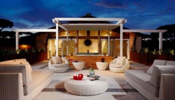 Villa Agrippina Gran Melia gay-friendly hotel patio at dusk. Luxurious outdoor seating, perfect for relaxing. Gay travel in Rome.