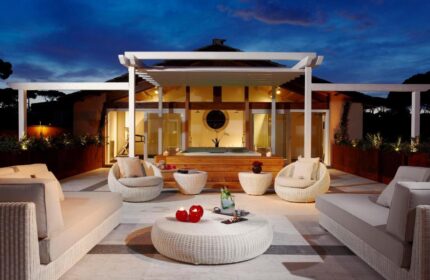 Villa Agrippina Gran Melia gay-friendly hotel patio at dusk. Luxurious outdoor seating, perfect for relaxing. Gay travel in Rome.