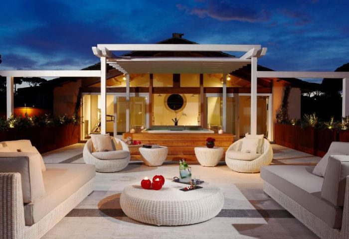Villa Agrippina Gran Melia gay-friendly hotel patio at dusk. Luxurious outdoor seating, perfect for relaxing. Gay travel in Rome.