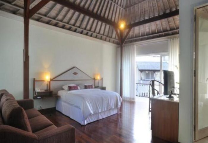 Villa Kresna Boutique and Suites, a gay-friendly hotel. Bedroom interior with a king-size bed, couch, and balcony. Great for gay travelers.