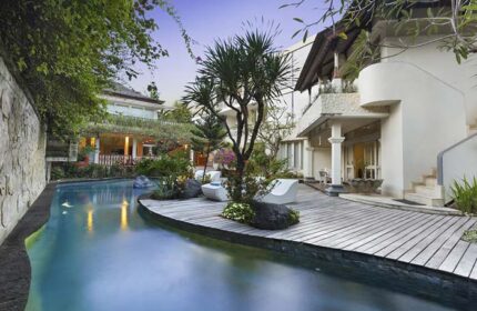 Villa Kresna Boutique and Suites, a gay-friendly hotel. Poolside view with modern decor, tropical plants, and inviting architecture. Perfect for gay travel.