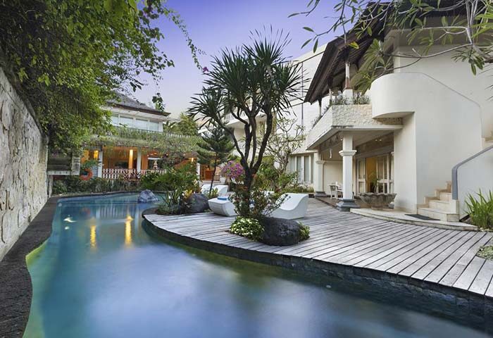 Villa Kresna Boutique and Suites, a gay-friendly hotel. Poolside view with modern decor, tropical plants, and inviting architecture. Perfect for gay travel.