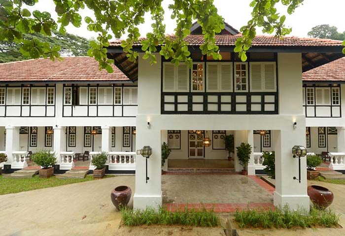 Villa Samadhi Singapore by Samadhi: Exterior view of the gay-friendly hotel. White facade, black trim, and lush greenery. A tranquil retreat.