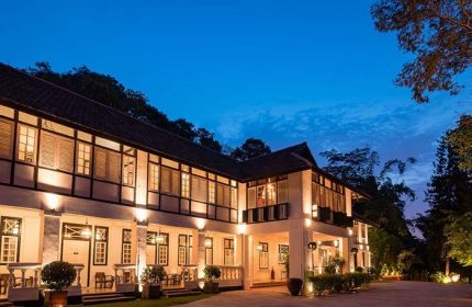Villa Samadhi Singapore by Samadhi, a gay-friendly hotel. Exterior view at dusk, showing the building's architecture and illuminated facade.