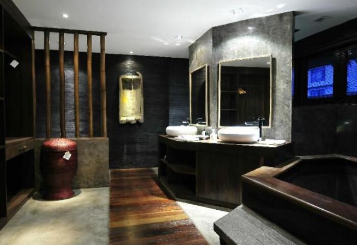 Villa Samadhi bathroom. Gay-friendly hotel with sinks, mirrors, wooden floors, and a dark, luxurious design. Perfect for gay travel.
