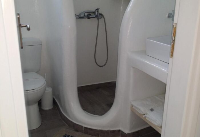 Villa Varnali Small Boutique gay-friendly hotel bathroom. Toilet, shower, sink, and towels in a white-themed boutique hotel room.