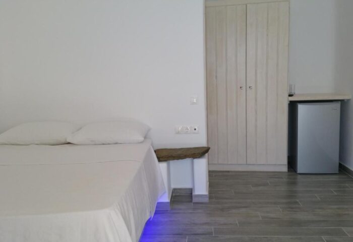 Villa Varnali Small Boutique gay-friendly hotel room. Minimalist design with double bed, mini fridge, and wardrobe. Ideal for gay travel.