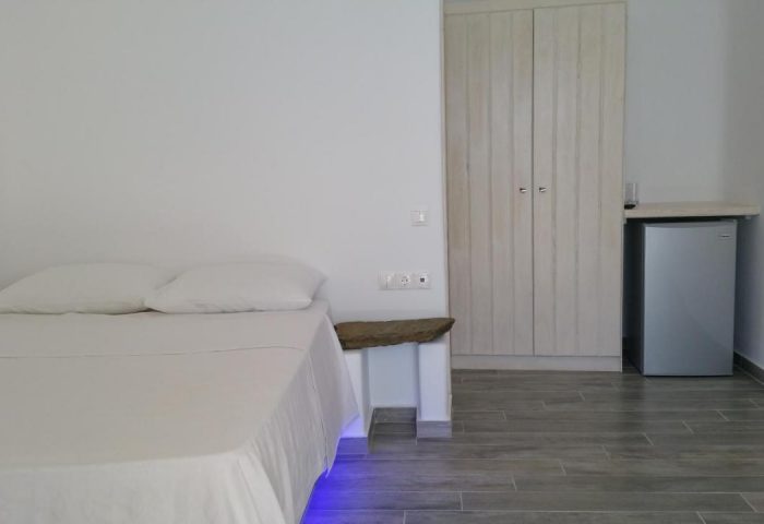 Villa Varnali Small Boutique gay-friendly hotel room. Minimalist design with double bed, mini fridge, and wardrobe. Ideal for gay travel.