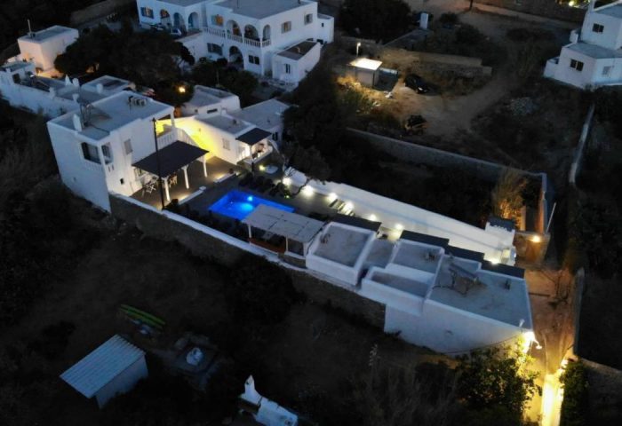 Villa Varnali Small Boutique, a gay-friendly hotel. Night aerial view of the illuminated pool at this luxury villa in Mykonos, Greece.