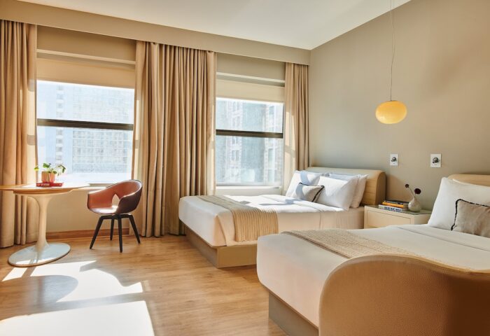 Virgin Hotels Chicago guest room with two beds. Gay-friendly hotel featuring modern design, city views, and comfortable accommodations.