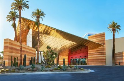Virgin Hotels Las Vegas, a gay-friendly Curio Collection by Hilton. Exterior view of the hotel entrance with desert landscaping.